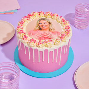 Decorative cake with a photo of a person on a purple tablecloth