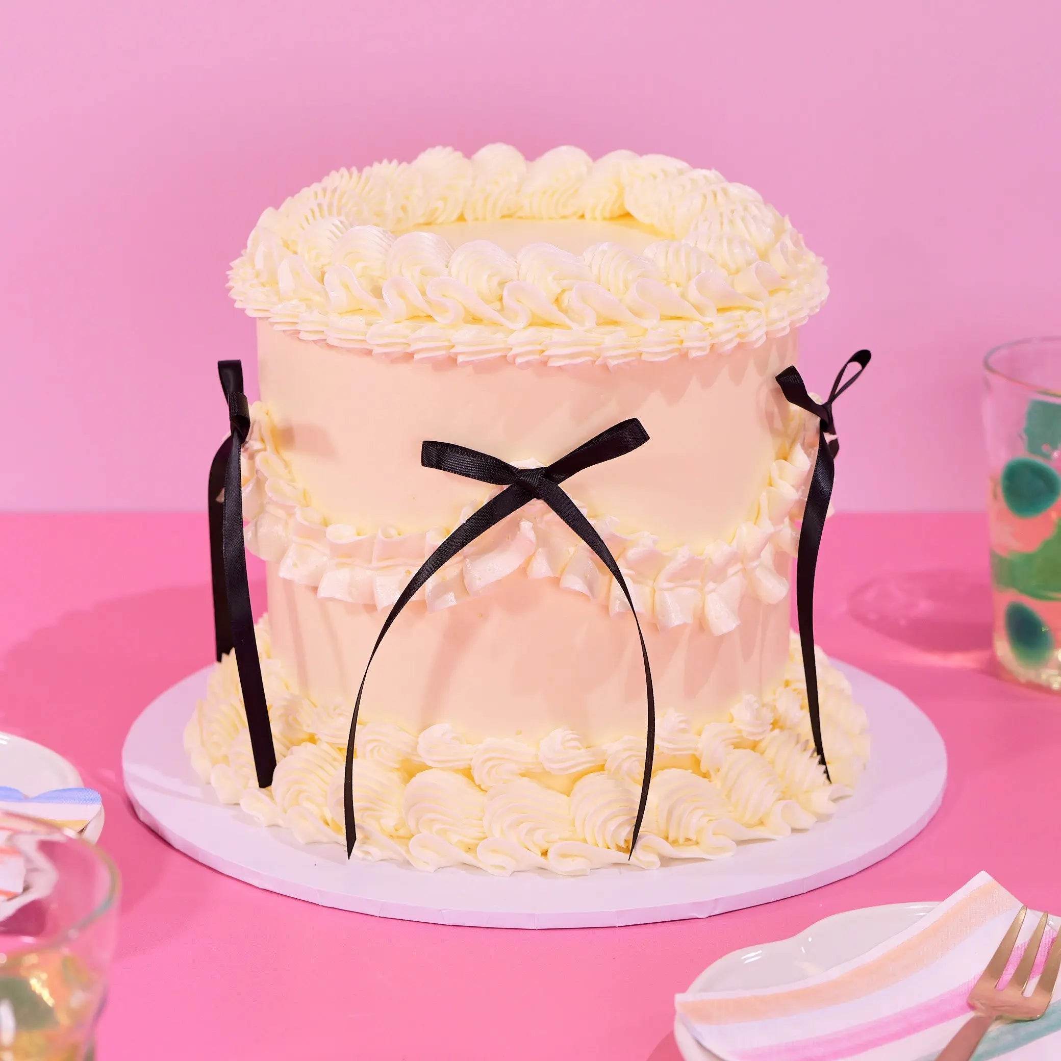 Vintage Cake - Single Colour with hand-piped Swiss Meringue icing, black ribbon detail, and six layers of sponge by Crumbs & Doilies