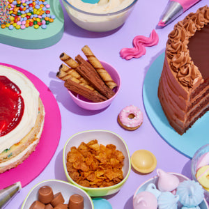 The makings of a bespoke decorated cake including sponge, icing and sprinkles