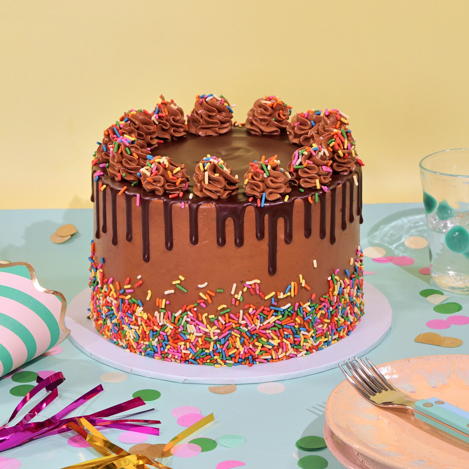 Chocolate Birthday Cake with chocolate drip, piped icing and colorful sprinkles by Crumbs & Doilies