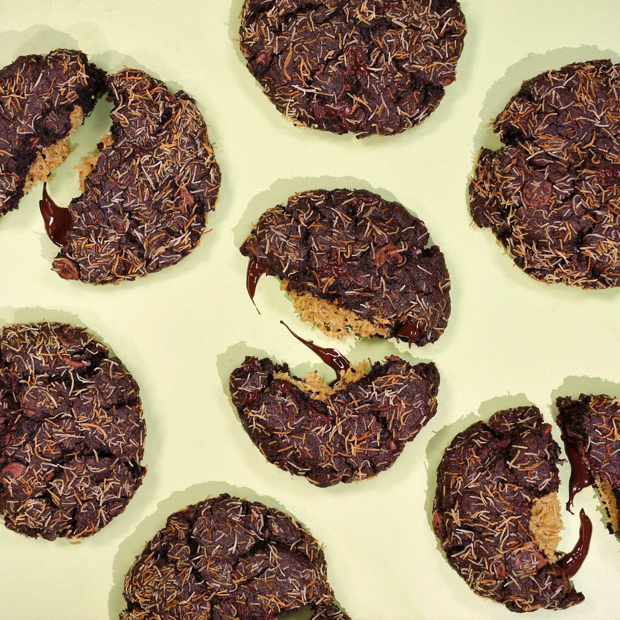 Dubai Chocolate Bar New York Cookie with melted chocolate, kunafa strands, and pistachio kunafa filling visible inside.