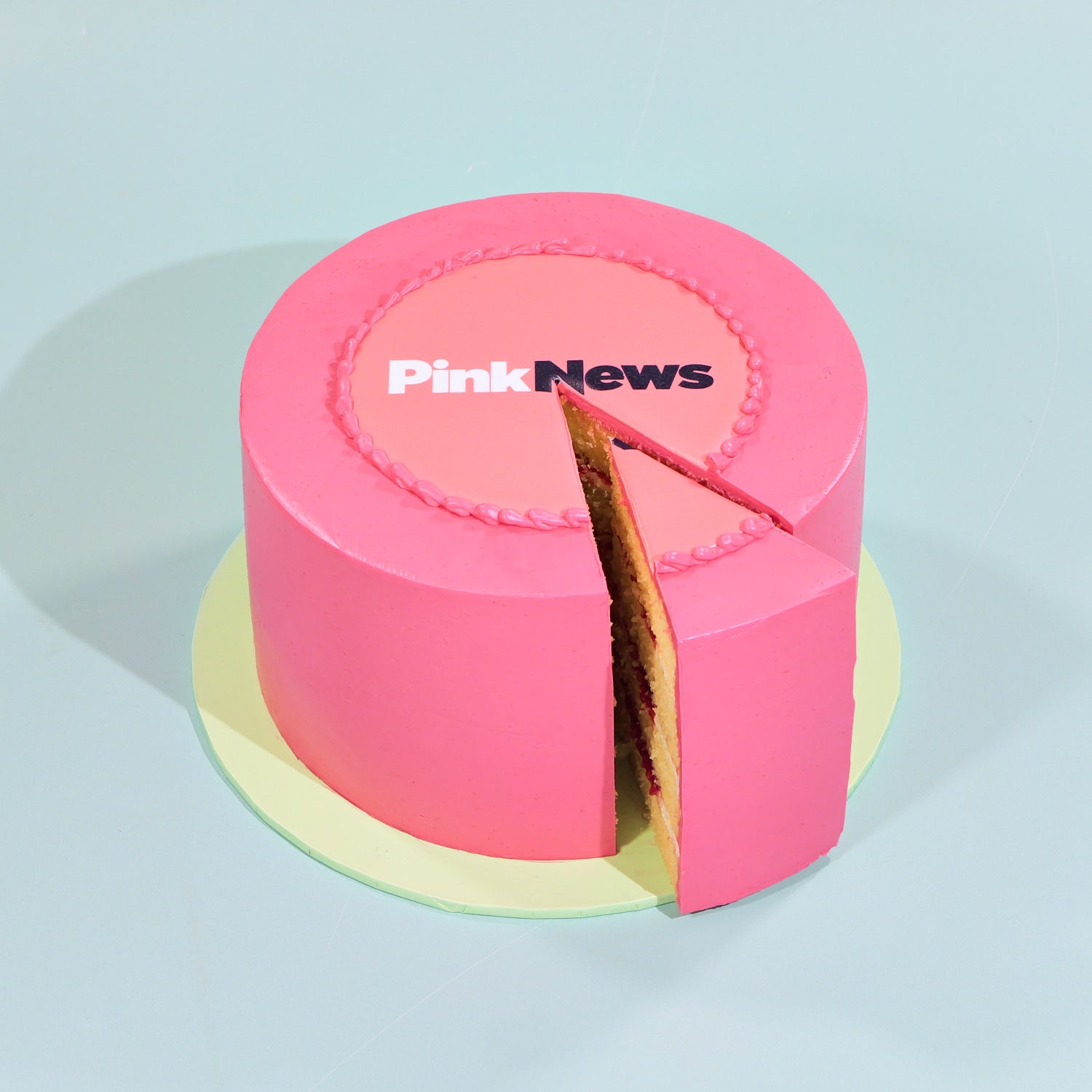 Gluten Free Corporate Cake with Logo featuring pink icing and custom edible logo plaque perfect for celebrations and events