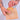 Almond Croissant New York Cookie being held above a Crumbs & Doilies branded paper bag with tattooed hands.