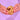 Salted Caramel Pecan New York Cookie with gooey salted caramel centre and toasted pecans held by hands against purple background