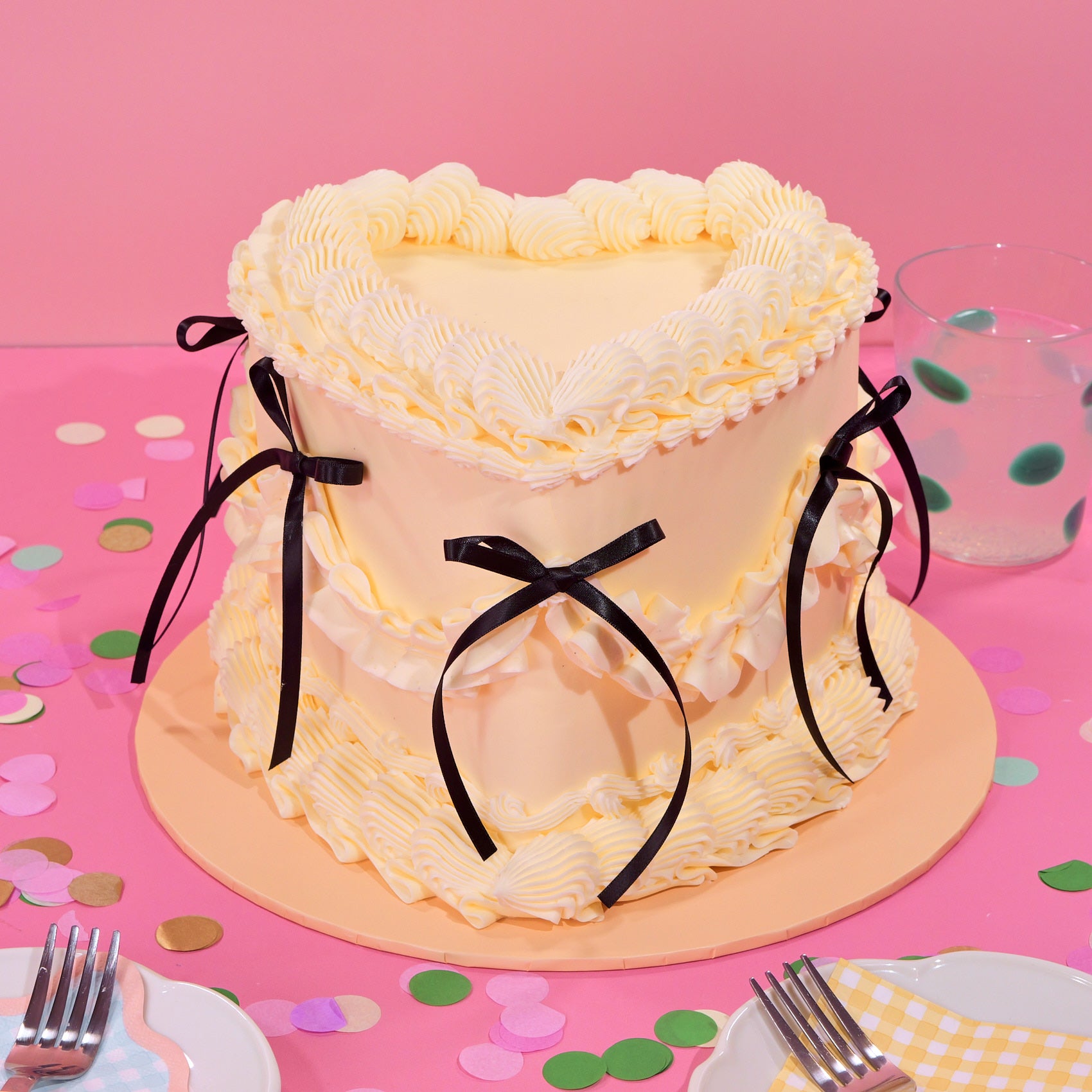 Vintage Heart Cake with creamy buttercream piping and black ribbon bows, displayed in gallery position 1 view