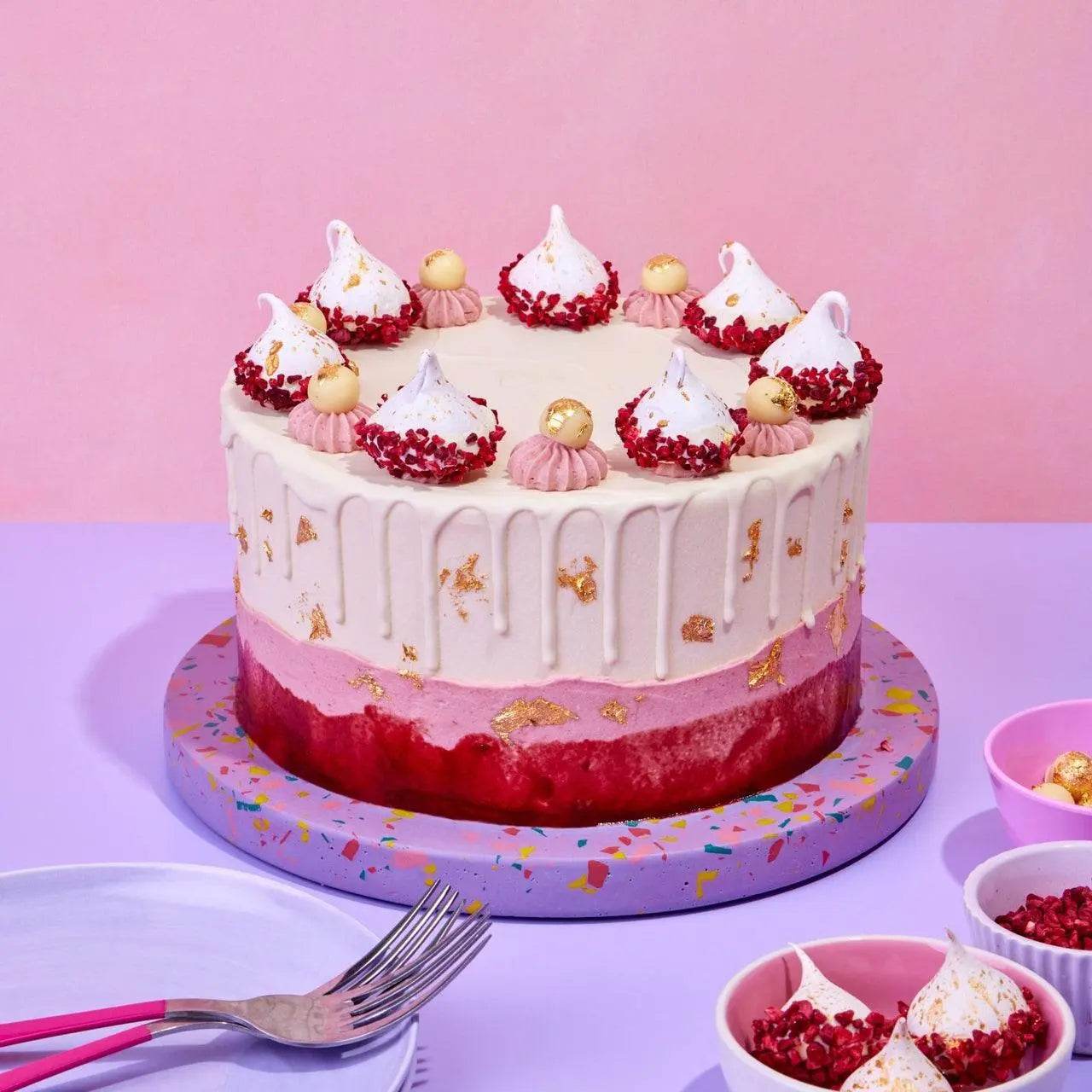 Raspberry & White Chocolate Cake with layers, white chocolate truffles, raspberry meringue, gold leaf by Crumbs & Doilies.